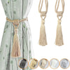 Set of two elegant beige tassel curtain tiebacks with twisted rope handles shown against a light green fabric.