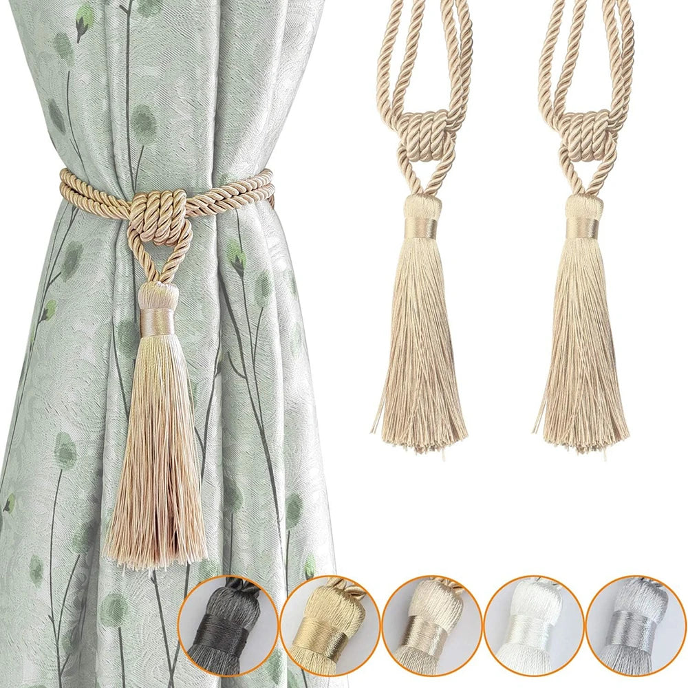 Set of two elegant beige tassel curtain tiebacks with twisted rope handles shown against a light green fabric.