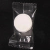 A clear plastic package containing a white compressed disposable towel for face and skin care.