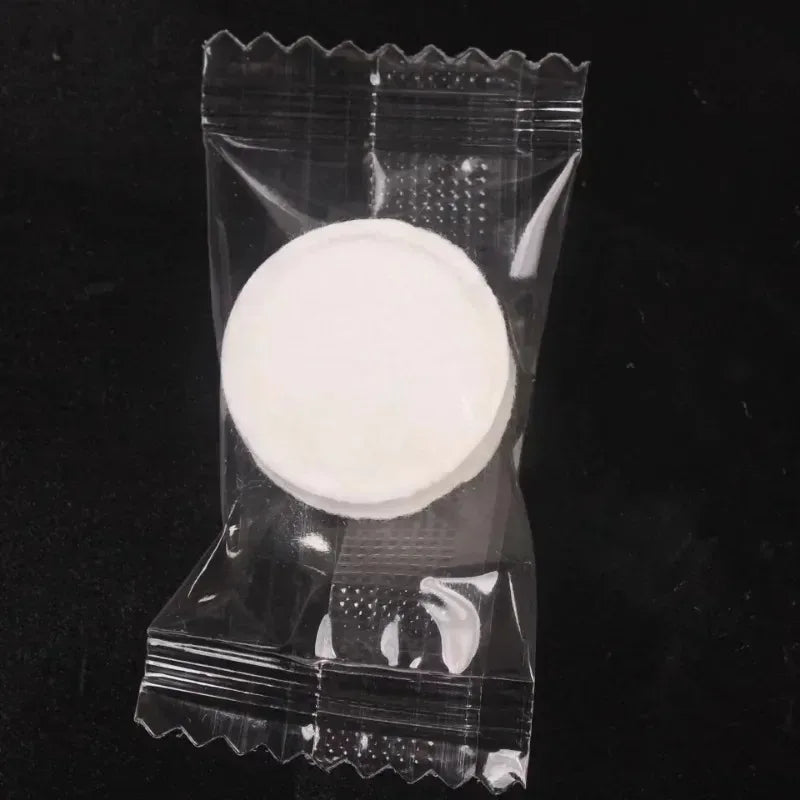 A clear plastic package containing a white compressed disposable towel for face and skin care.