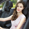 A young woman sits in a car seat, looking at the camera. The image features an ergonomic car neck pillow.