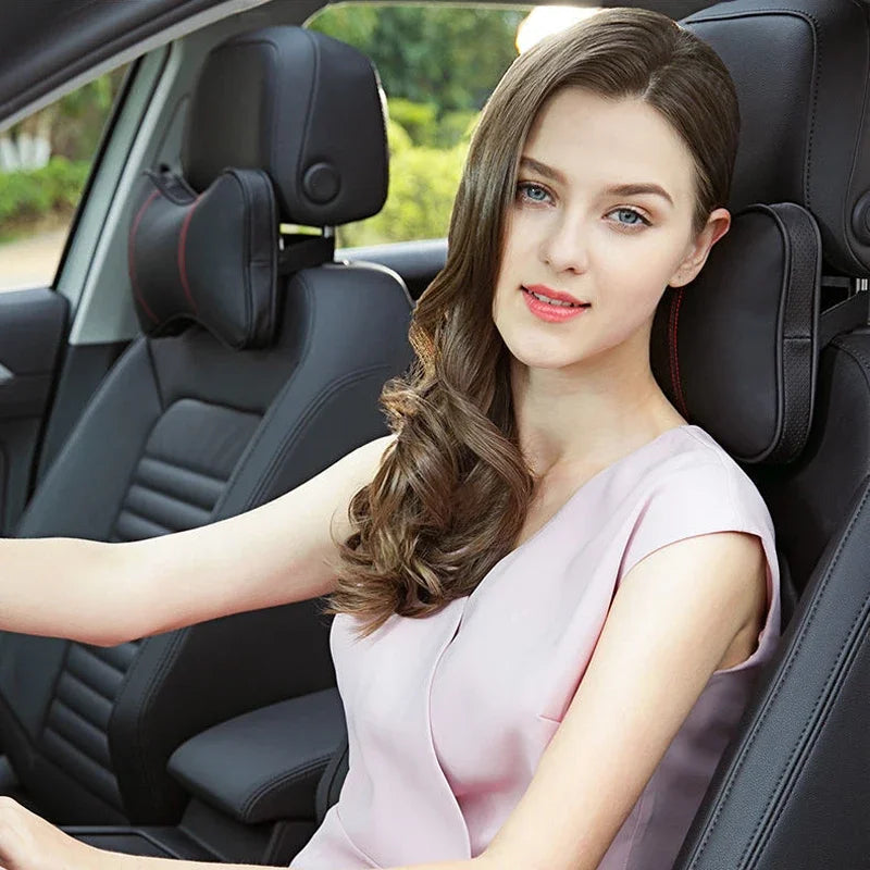 A young woman sits in a car seat, looking at the camera. The image features an ergonomic car neck pillow.