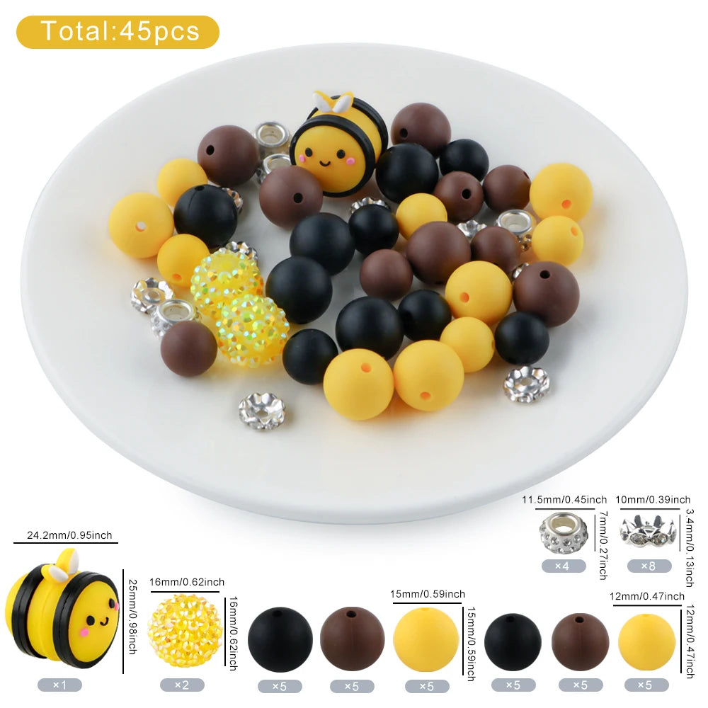 A collection of 45 round silicone beads in various colors including yellow, black, and brown, displayed on a white plate.