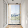 Modern clover LED ceiling light fixture installed in a bright room with a view of mountains.