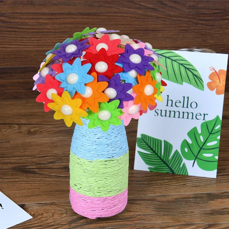 A colorful bouquet of felt flowers and buttons arranged in a cylindrical vase on a wooden surface.