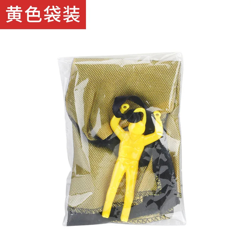 A yellow hand-throw parachute toy with a mini soldier is visible inside a clear plastic bag.