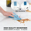 A hand is squeezing a blue microfiber towel, demonstrating high absorbency and quality material contents for kitchen cleaning
