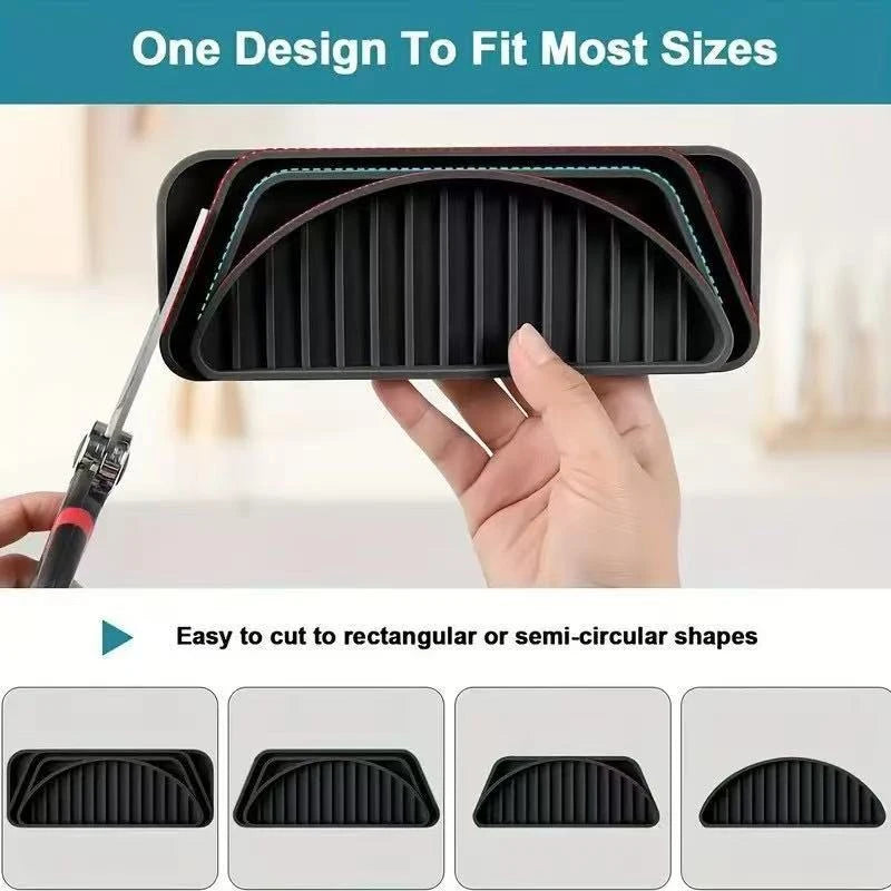 A hand holds a black silicone drip tray with raised ridges, demonstrating its design for various sizes.