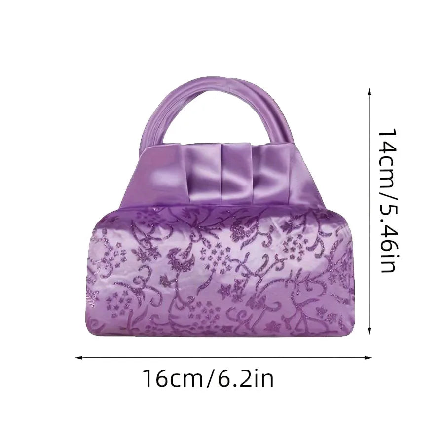 A purple princess pretend makeup kit purse with a satin-like finish and floral pattern.