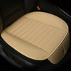 A beige breathable PU leather car seat cover placed in a dark car interior.