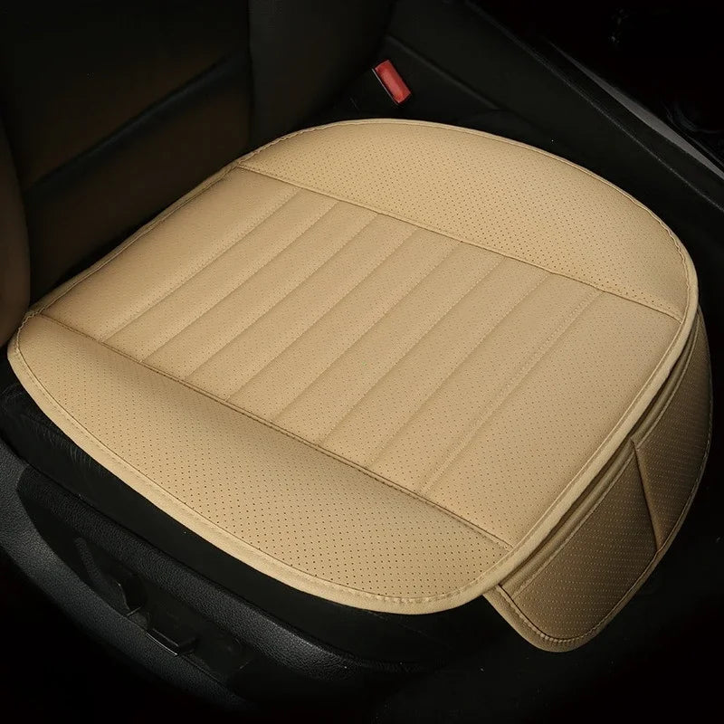 A beige breathable PU leather car seat cover placed in a dark car interior.