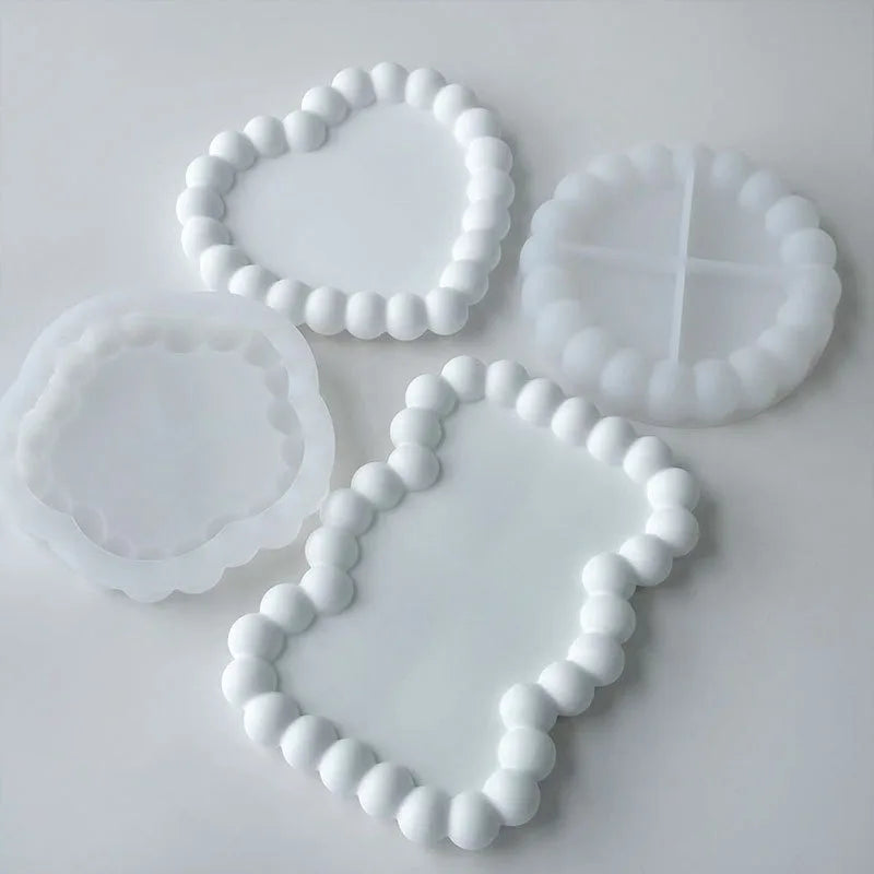 White silicone tray molds shaped like hearts and leaves for crafting resin, gypsum, and clay