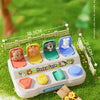 A surprise box containing a plastic animal world toy set with various stuffed animals for sensory learning.