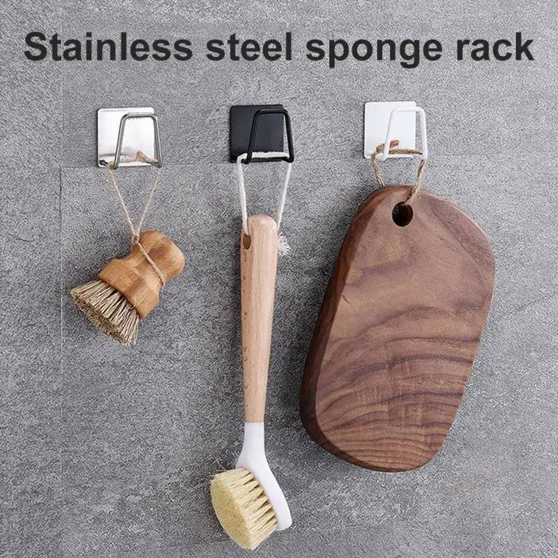 Stainless steel sponge rack featuring a wooden handle and bristles mounted on a wall.