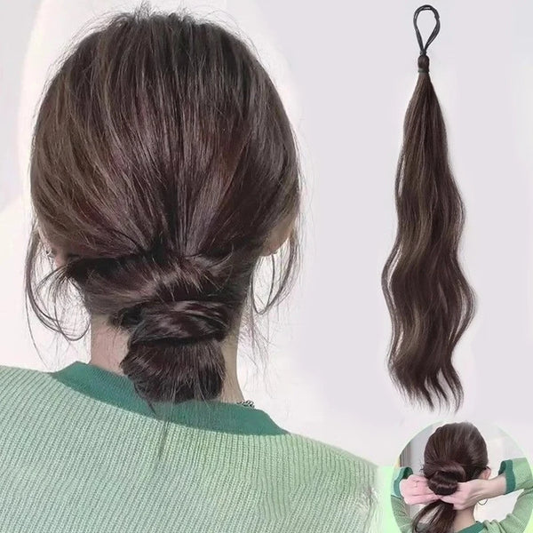 A woman shows off a long wavy synthetic ponytail hair extension styled in a high ponytail.