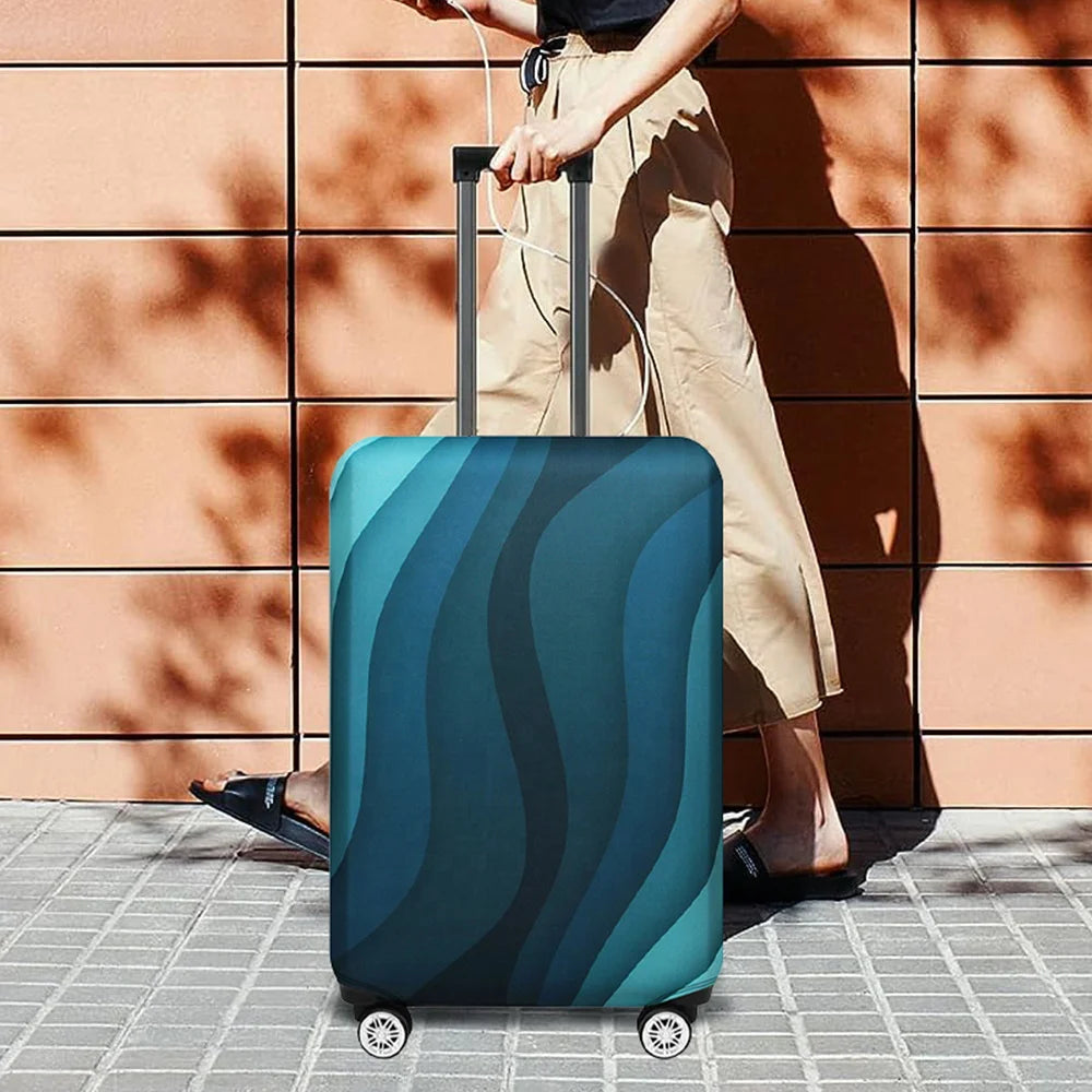 A teal and dark blue stretchable suitcase protector cover is shown being pulled by a person outdoors.