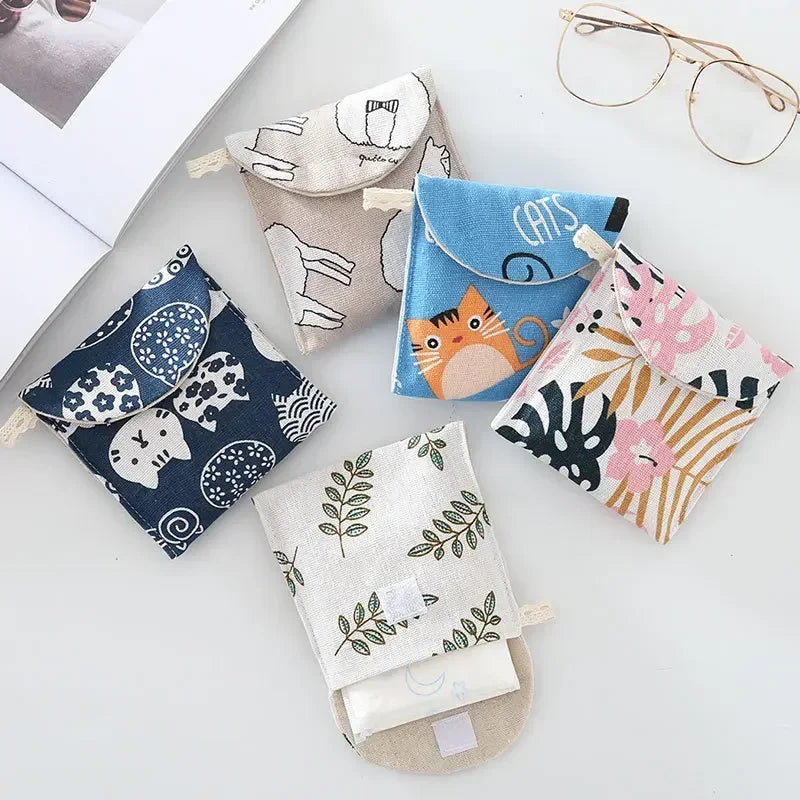 A collection of handmade fabric pouches and glasses cases featuring various animal prints and floral patterns.