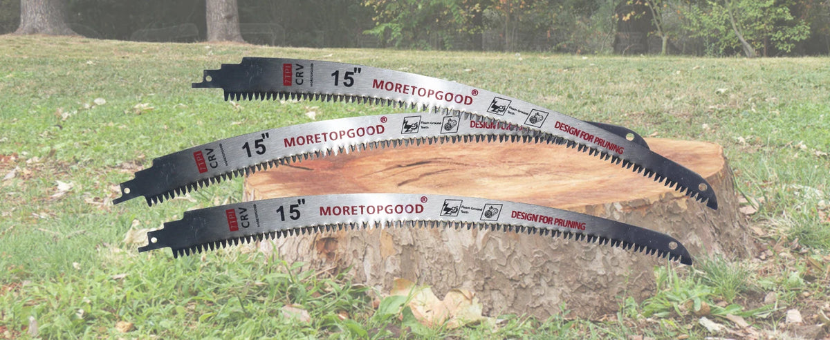 Three 15 inch Moretopgood design for pruning reciprocating saw blades are displayed on a wooden block outdoors.