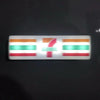 A rectangular fridge magnet featuring the flag of a country with horizontal stripes and a stylized red number 7.