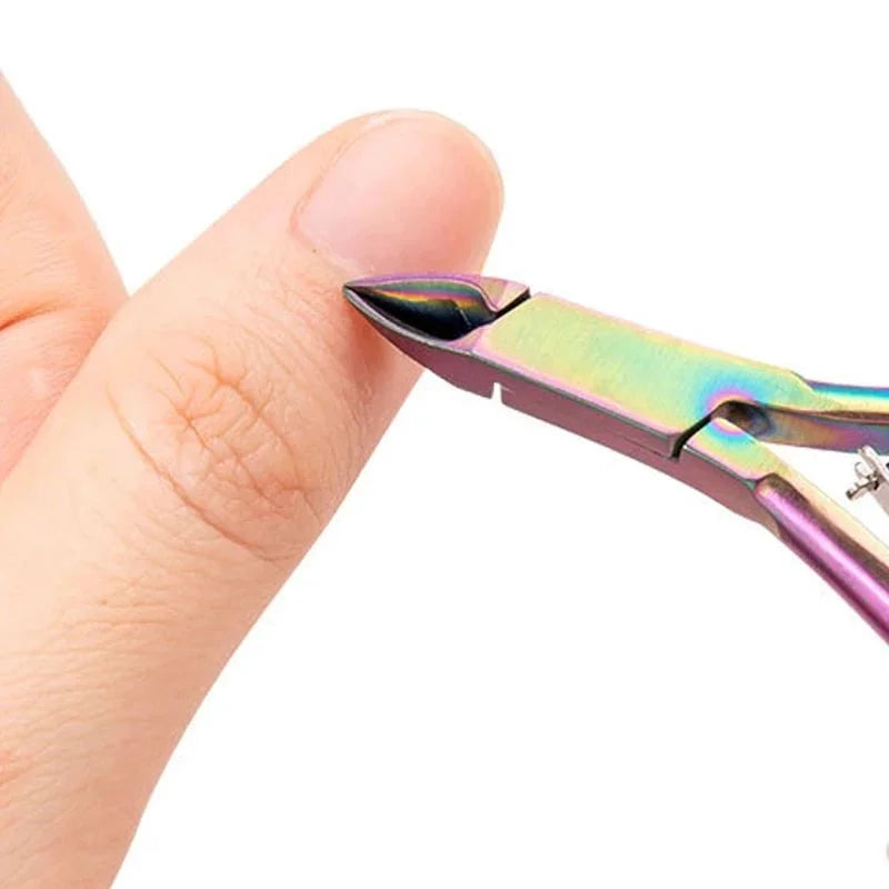 A hand is holding professional stainless steel cuticle nippers, showing the metal blades and handles.