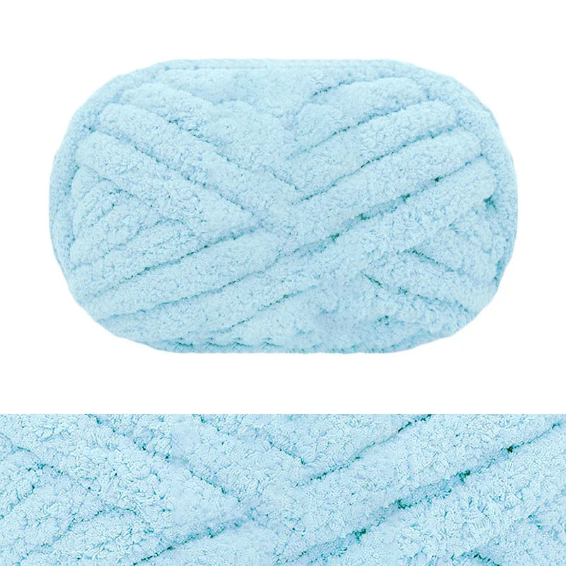 A ball of light blue chunky chenille yarn with a textured, braided appearance.