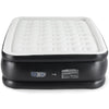 A black elevated air mattress with a white, quilted surface and a control panel.