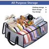 A gray collapsible storage box filled with clothing, books, and a teddy bear for all-purpose storage.