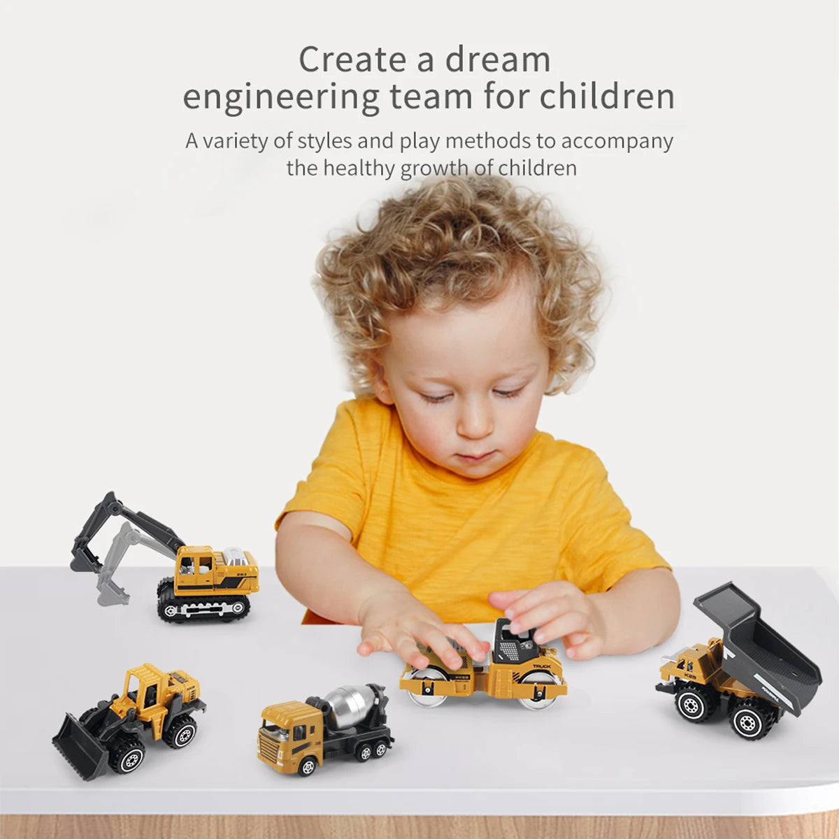 A young child is playing with a set of six die-cast construction truck toys including an excavator, loader, and tractor.