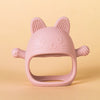 A pink silicone cat teether with pointed ears and whiskers is shown against a light background.