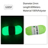 A spool of bright green glow-in-the-dark polyester yarn labeled G005F for knitting and crochet.
