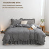 A plaid duvet cover set with two pillowcases displayed on a bed.