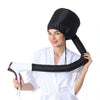 A woman is holding a black reusable hair drying and conditioning cap.