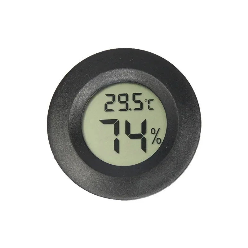 A round, black digital thermometer displaying 29.5°C and 74% humidity.