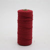 A spool of red macrame cord, 3mm/4mm thickness, used for crafting.