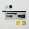 A transparent travel toiletry bag with a hanging hook, featuring black and light blue components and a toothbrush.