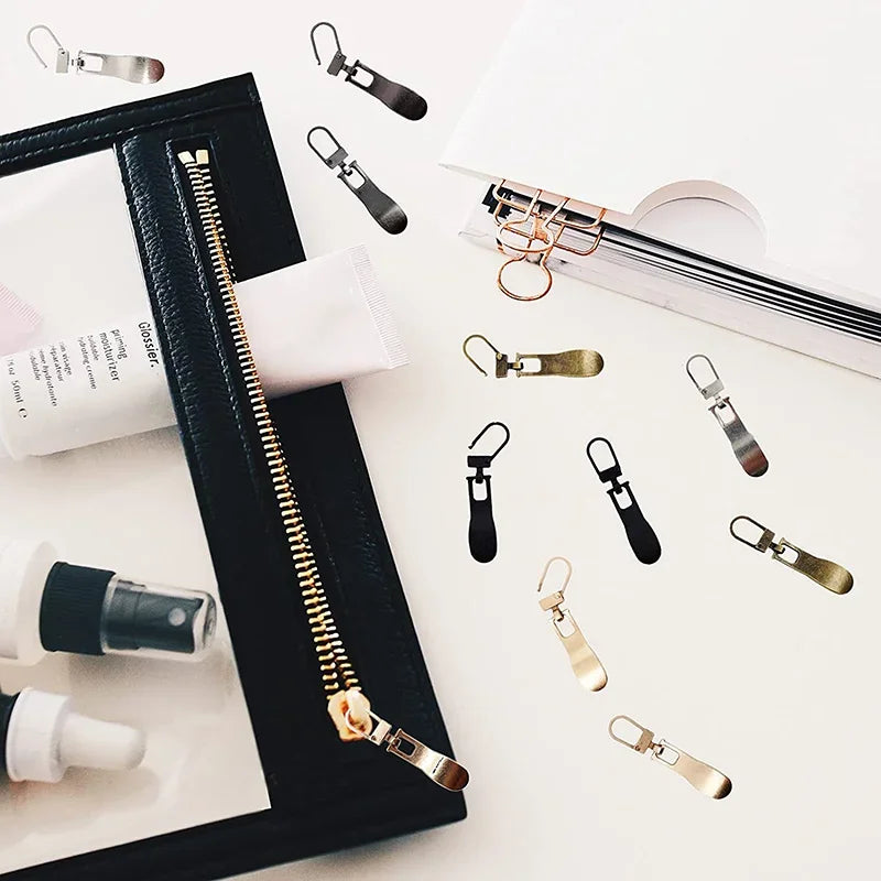 A collection of durable metal zipper pull replacement sliders for luggage, bags, and jackets displayed on a white background.