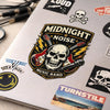 A graphic design featuring a skull and guitar motif for a music band decal on a white surface.