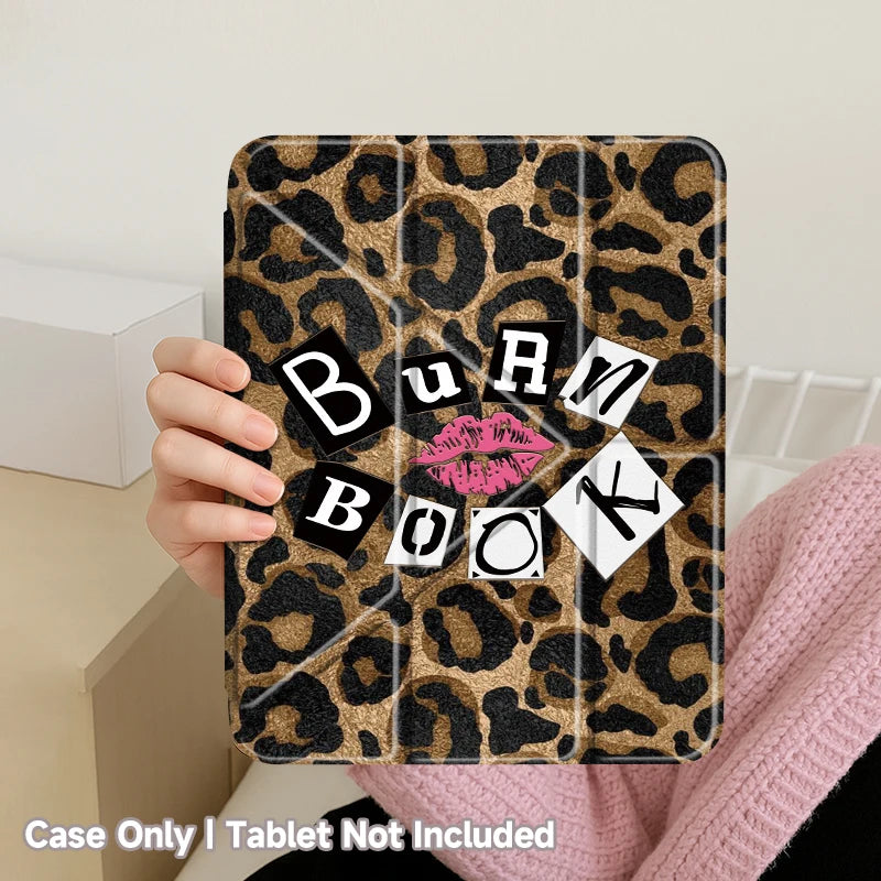 A leopard print case for a tablet is held by a hand against a light background.