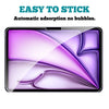 A close-up of a purple tempered glass screen protector being applied to an iPad screen.