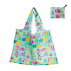 A light blue reusable shopping tote bag featuring tropical fruit and leaf patterns.