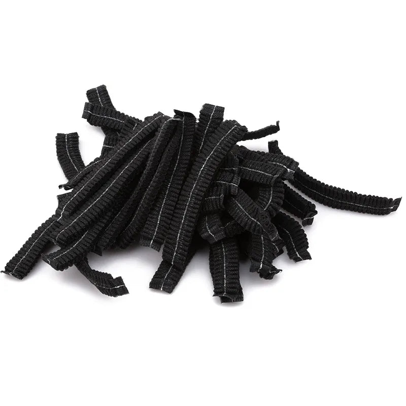 A pile of black disposable hair net caps for microblading and permanent makeup.