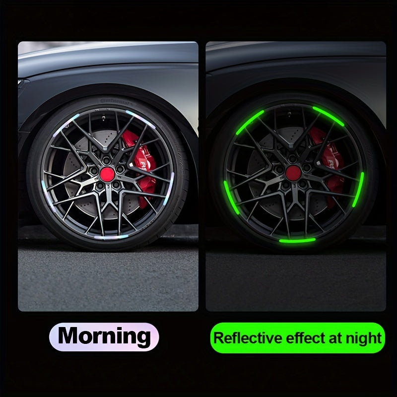 Close-up of a black alloy wheel with red brake calipers and green reflective stickers on the spokes.
