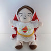 A soft white plush of Jesus wearing a red cape and yellow garment with closed eyes.