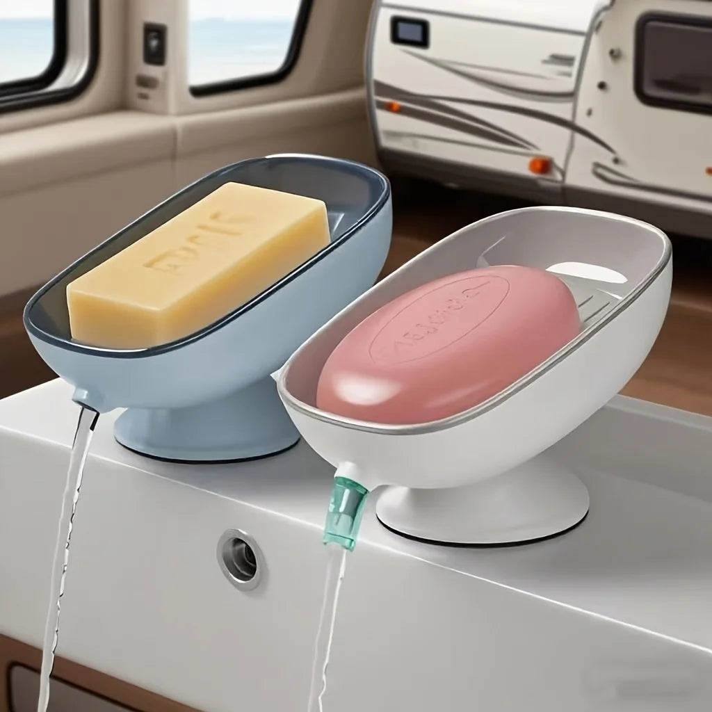 A white soap dish with a pink soap bar and a clear draining tray is shown on a counter.