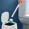 A hand is using a white cleaning pad to wipe the inside of a toilet bowl.