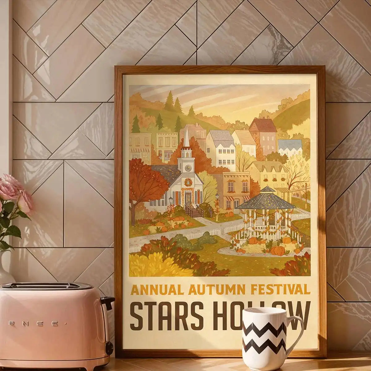 A framed canvas art print depicting a village scene for an annual autumn festival with warm colors and foliage.