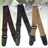 A set of vintage cross pattern guitar straps in brown, black, and tan leather.