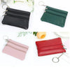 Three compact PU leather coin purses in black, green, and pink with silver clasps