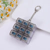 A clear silicone tactile clicking keyboard keychain fidget toy with a silver keyring attached.