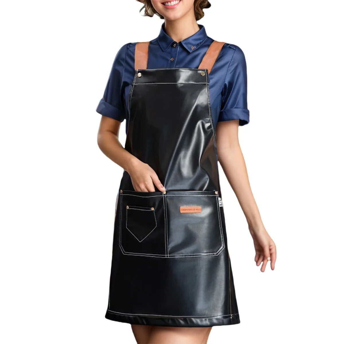 A woman wearing a black PU leather multi-pocket kitchen apron over a blue shirt.